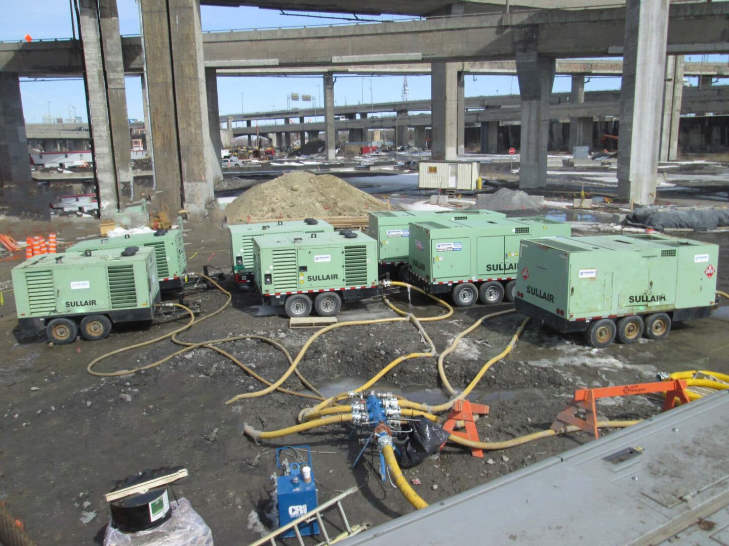 Large construction site Sullair Rental equipment.  Tow behind models air compressors
